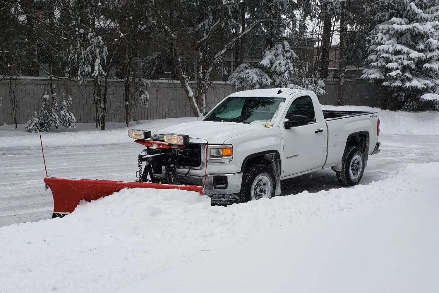 Snow plow clearing a London property